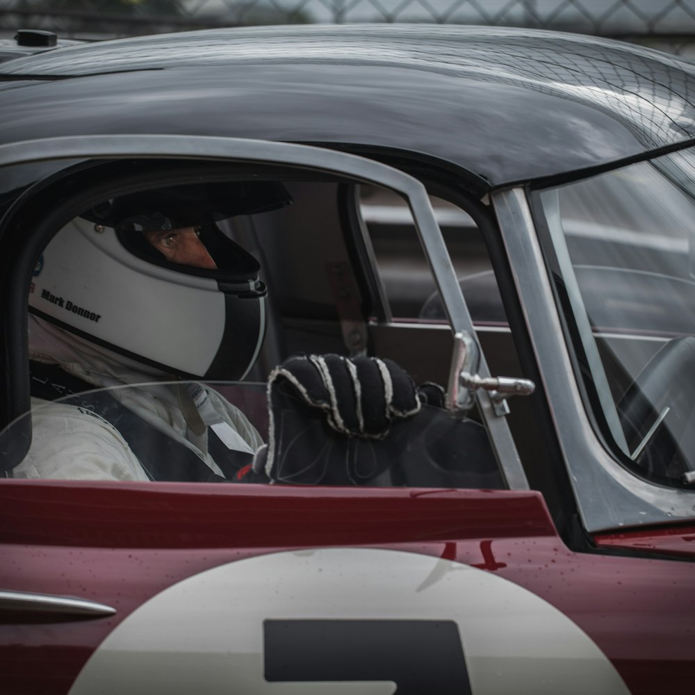 man in red and white car