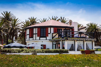 A freshly painted house exterior gleaming under the California sun with crisp black and gold accents.