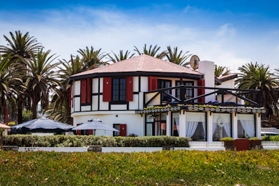A freshly painted house exterior gleaming under the California sun with crisp black and gold accents.