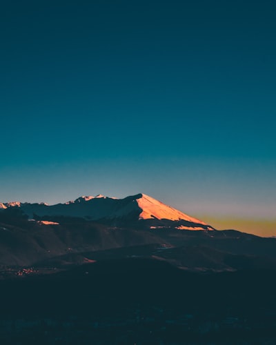 brown mountains under blue sky during night time