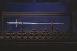 black and gold cross on black metal fence