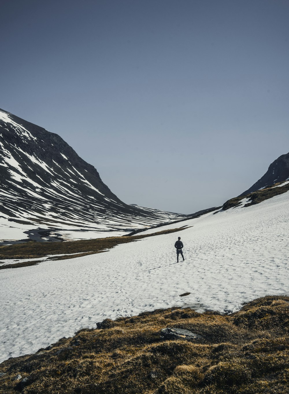 person walking on snow covered field during daytime