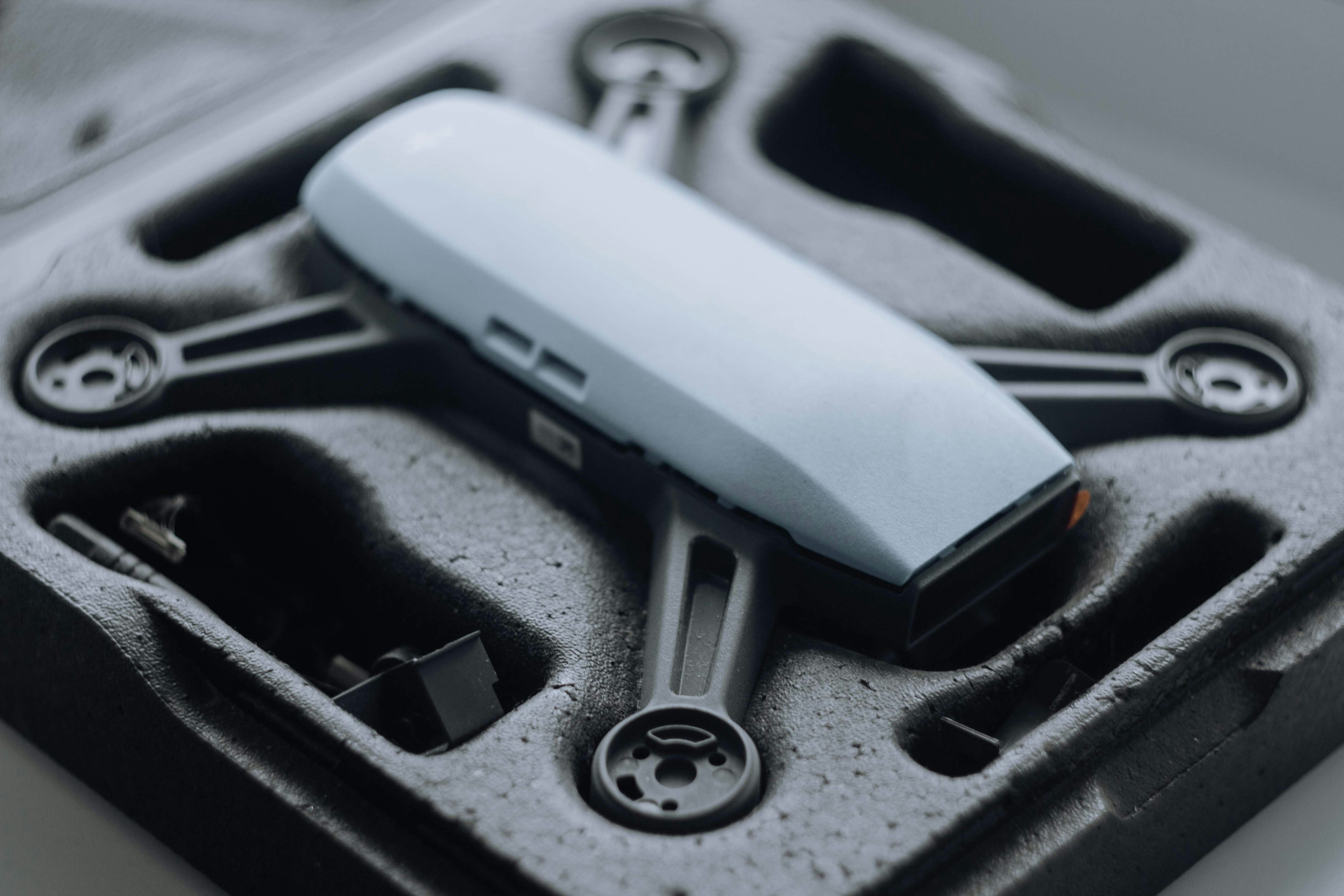 Technician using a tablet to run diagnostics on an electric car battery pack