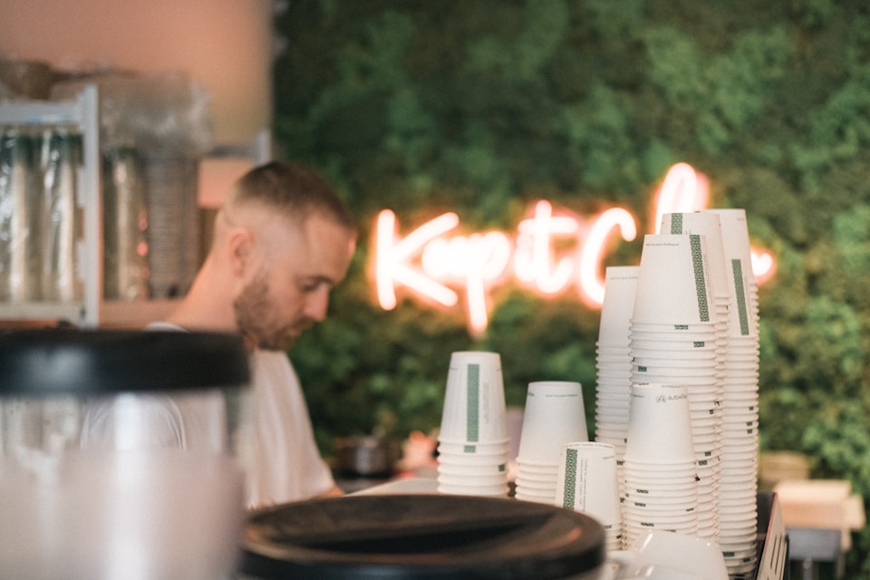 A business owner working in his store behind the counter