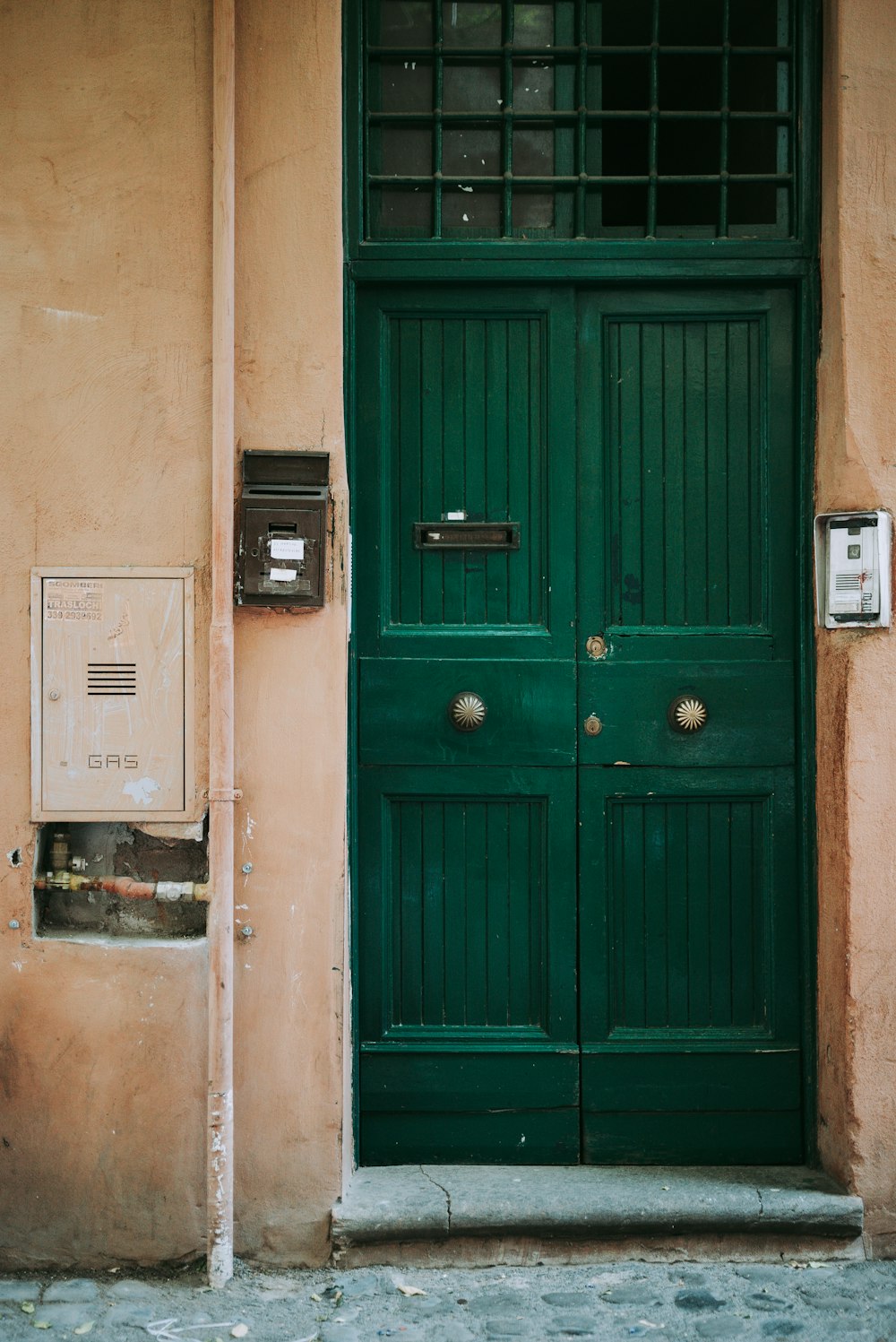 blue wooden door with white wall mounted device