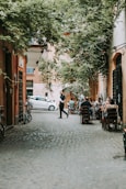 people sitting on chairs near road during daytime