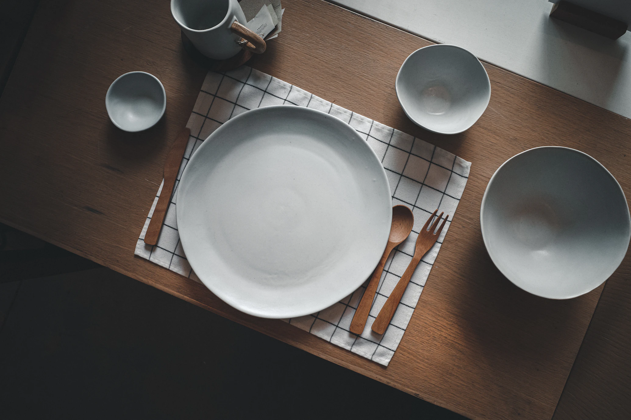 White Ceramic Dinnerware Set Displayed on Kitchen Shelves