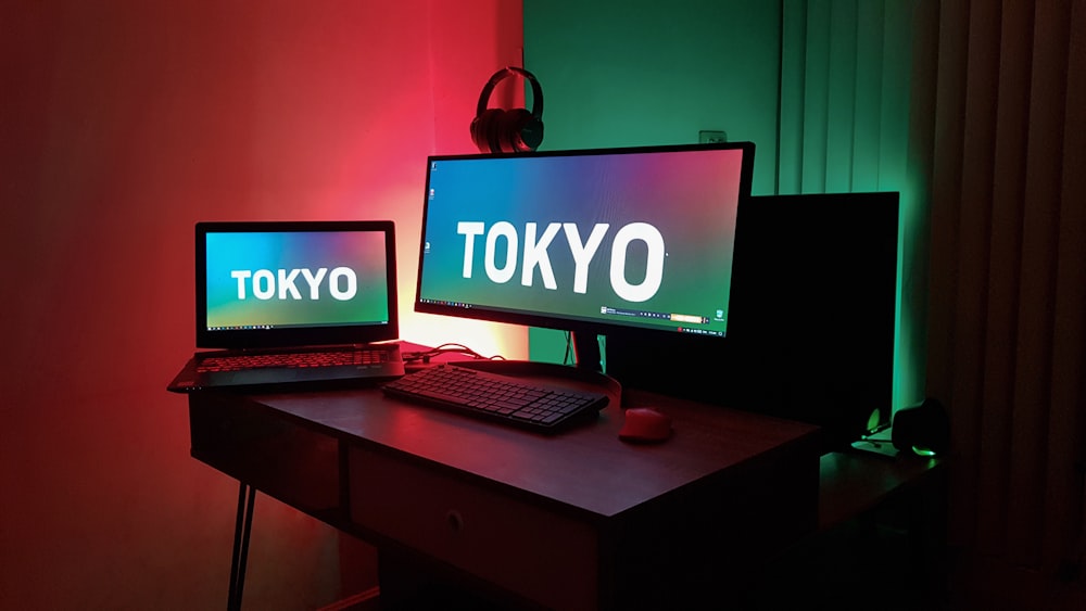 black laptop computer on brown wooden desk