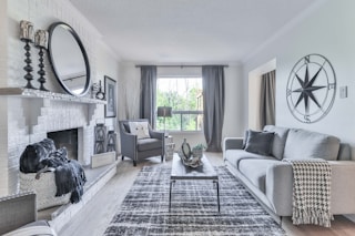 white and black plaid sofa near window