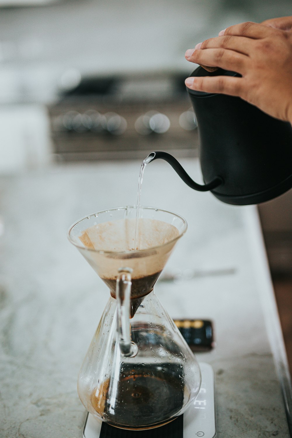 person pouring water on clear glass cup