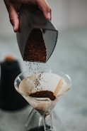 Close-up of coffee grounds transforming into compost material.