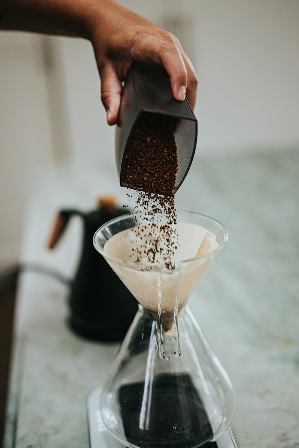 person pouring milk on clear glass