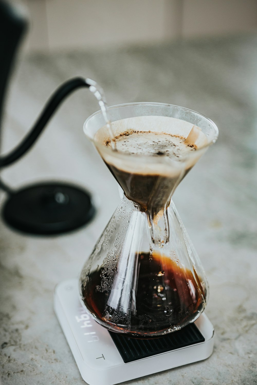 clear glass cup with brown liquid