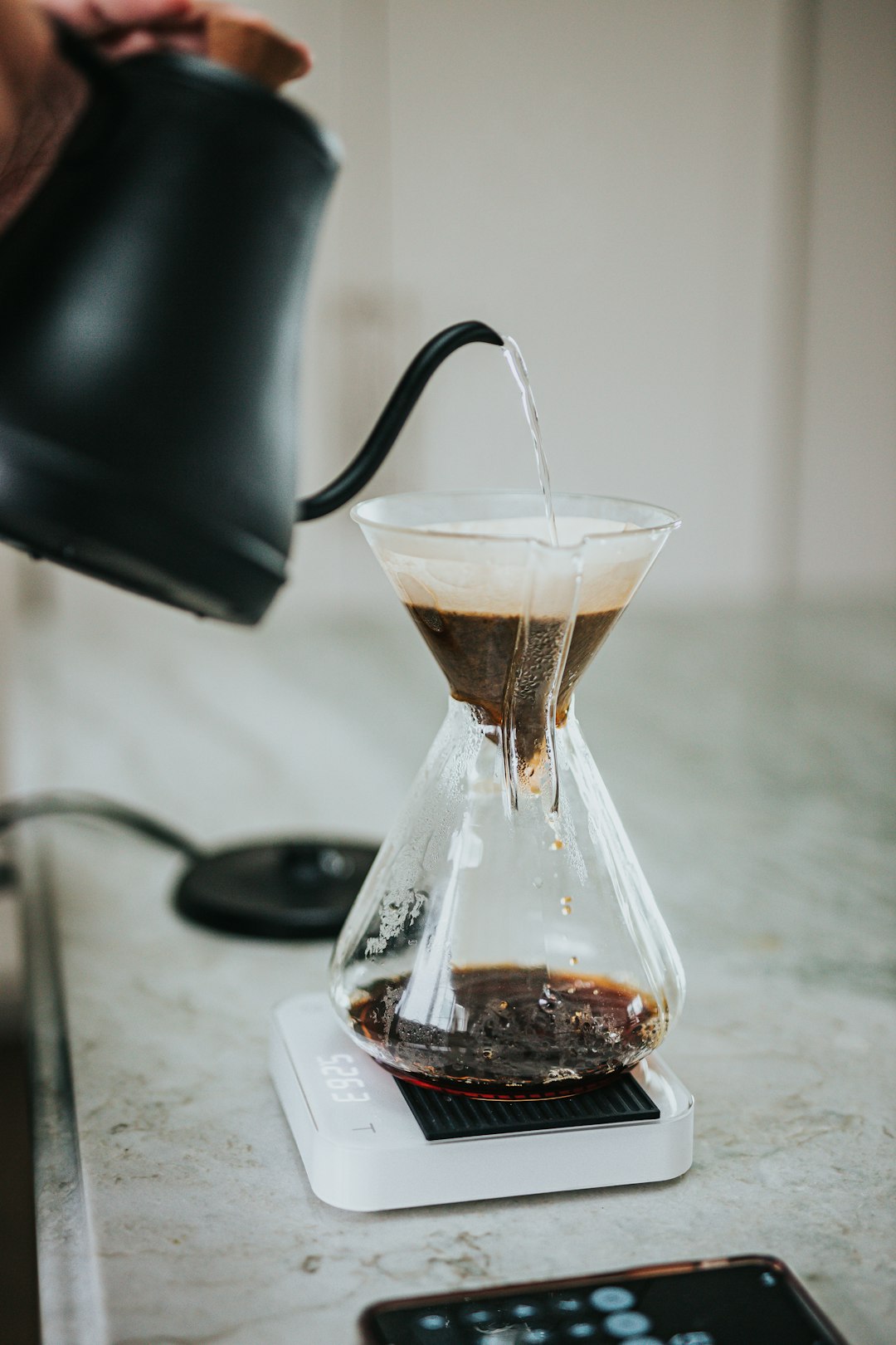 clear glass coffee pot on white paper