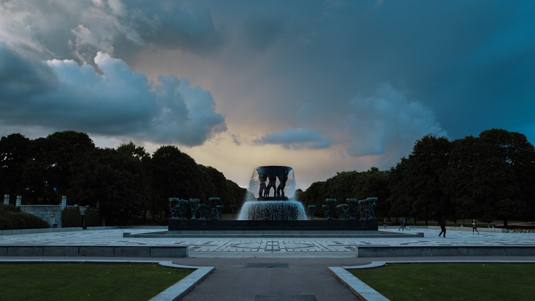 gray concrete fountain under cloudy sky during daytime