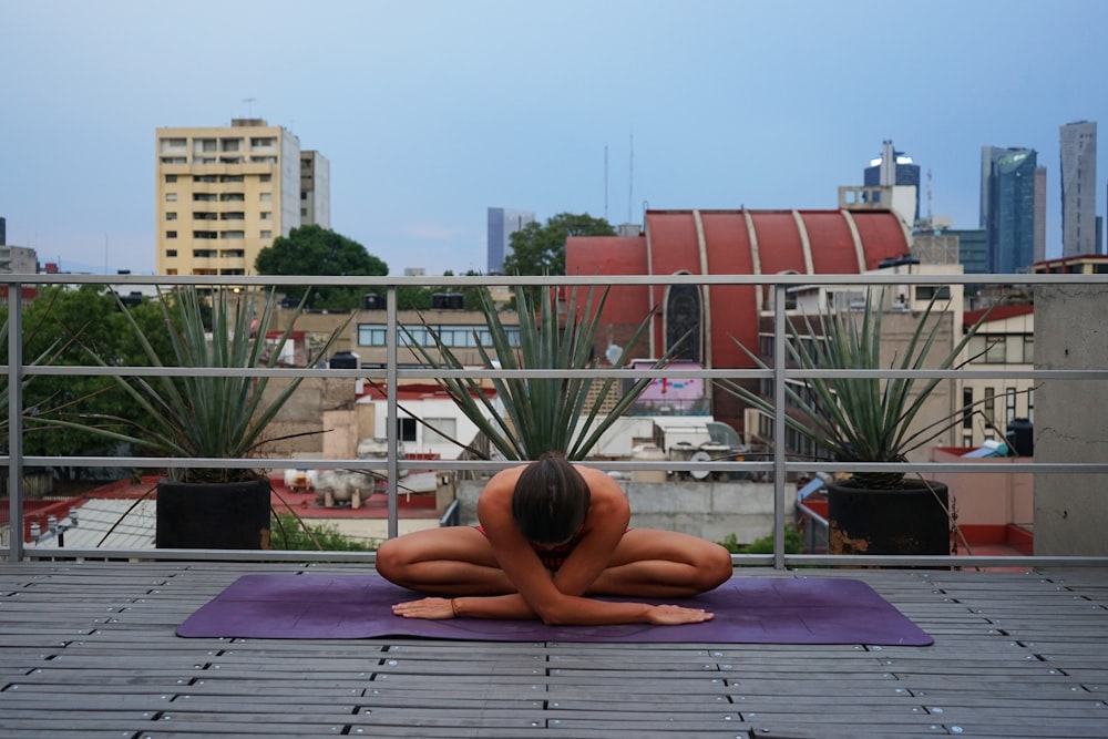 woman lying on blue mat on swimming pool during daytime