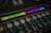 A close-up of an audio mixing console featuring various buttons and labeled controls. The panel includes labels like 'Muziek' and 'Film' with colored backlighting in green, yellow, and purple. Several rows of buttons are visible, each with different functions such as 'Mute' and 'Sel'. The overall look is technical and organized, suggesting a professional audio setup.