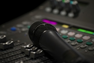 black microphone on black audio mixer