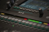 Close-up of professional sound mixing console in use at an event.