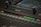 A close-up of a recording console with sound waves on a screen.