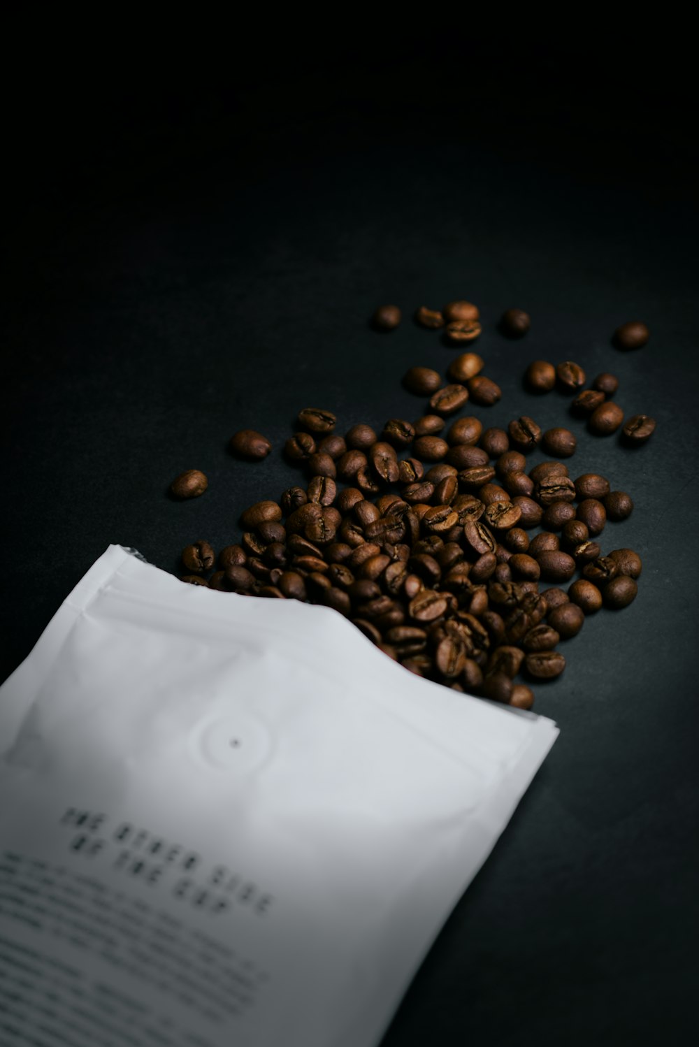 brown coffee beans on black table