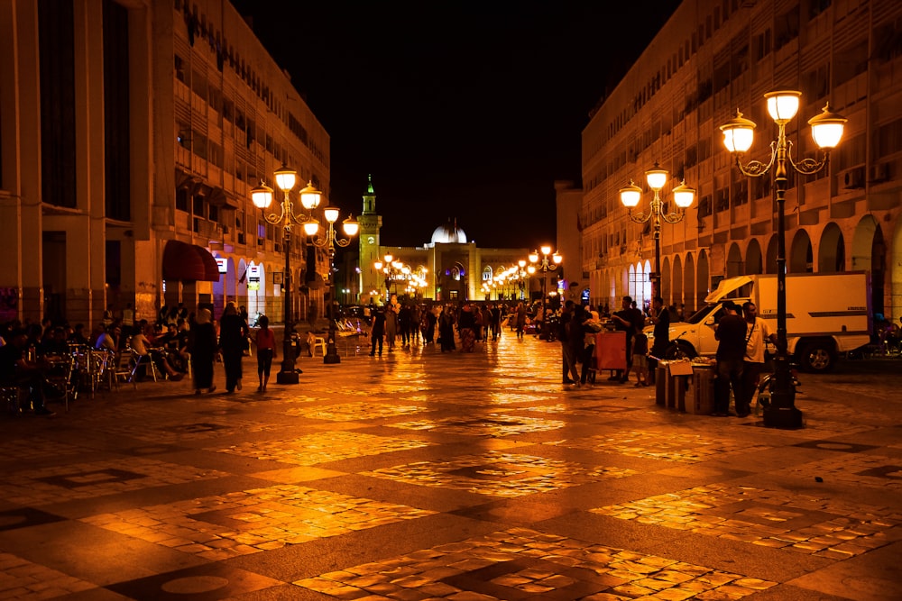 people walking on street during night time