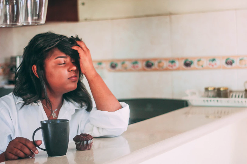 woman in white long sleeve shirt sitting on bathtub covering her face with her hair