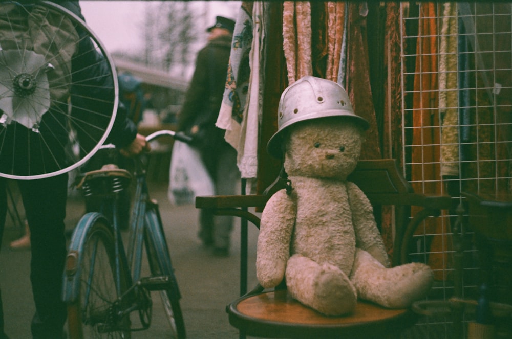 brown teddy bear on black wheelchair