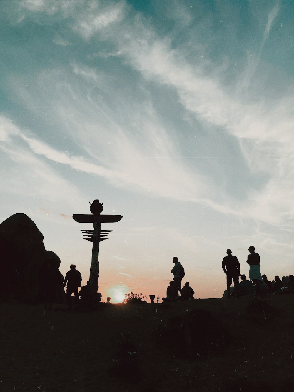 silhouette of people standing near cross during daytime