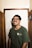 man in green crew neck t-shirt wearing black framed eyeglasses