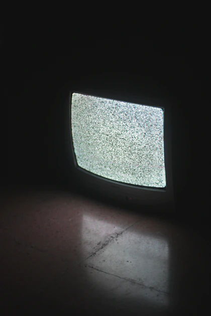 A vintage CRT television displaying a retro game with visible scanlines