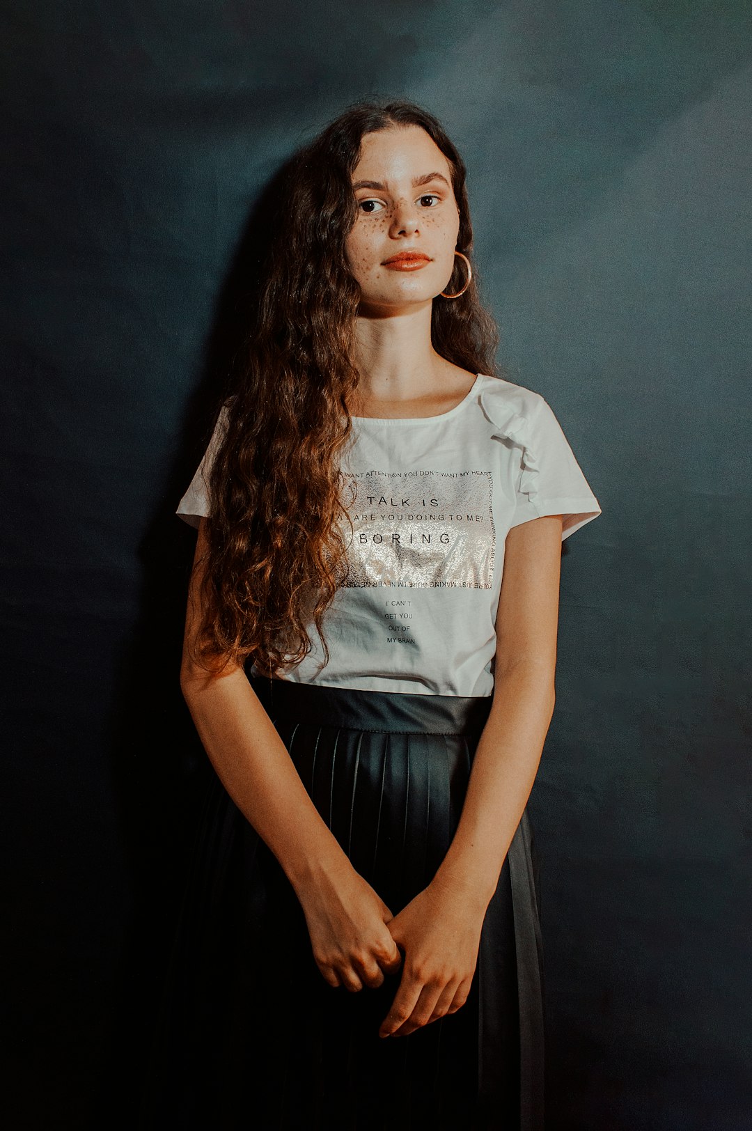 woman in white and black crew neck t-shirt and black skirt