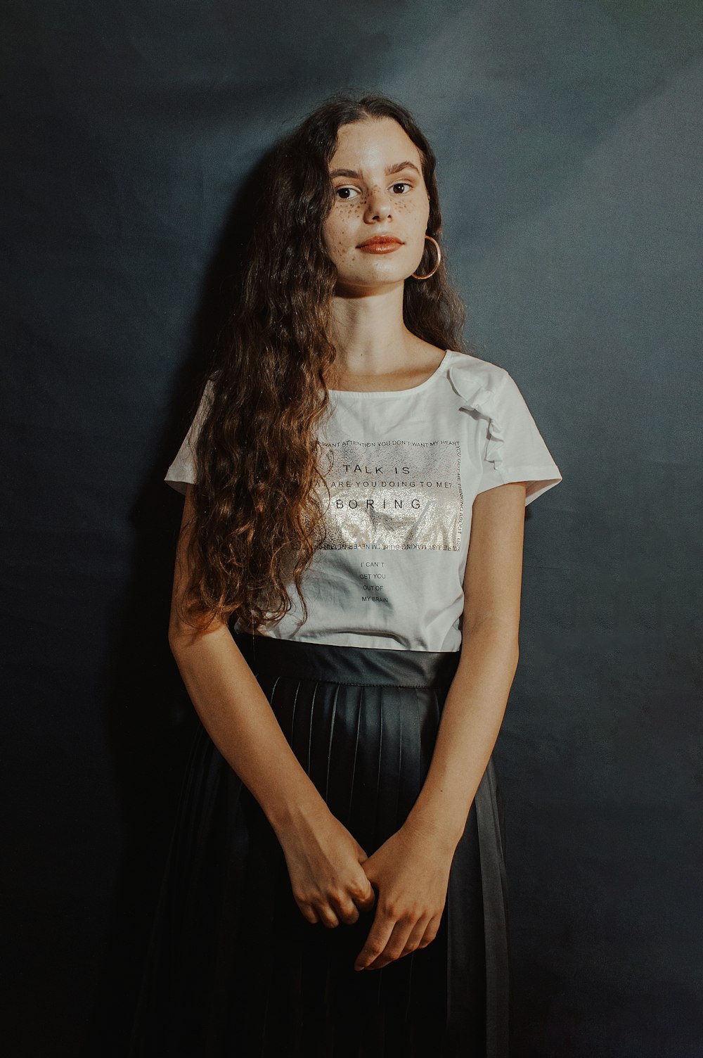 woman in white and black crew neck t-shirt and black skirt