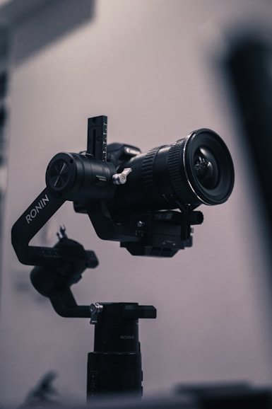 black dslr camera on tripod