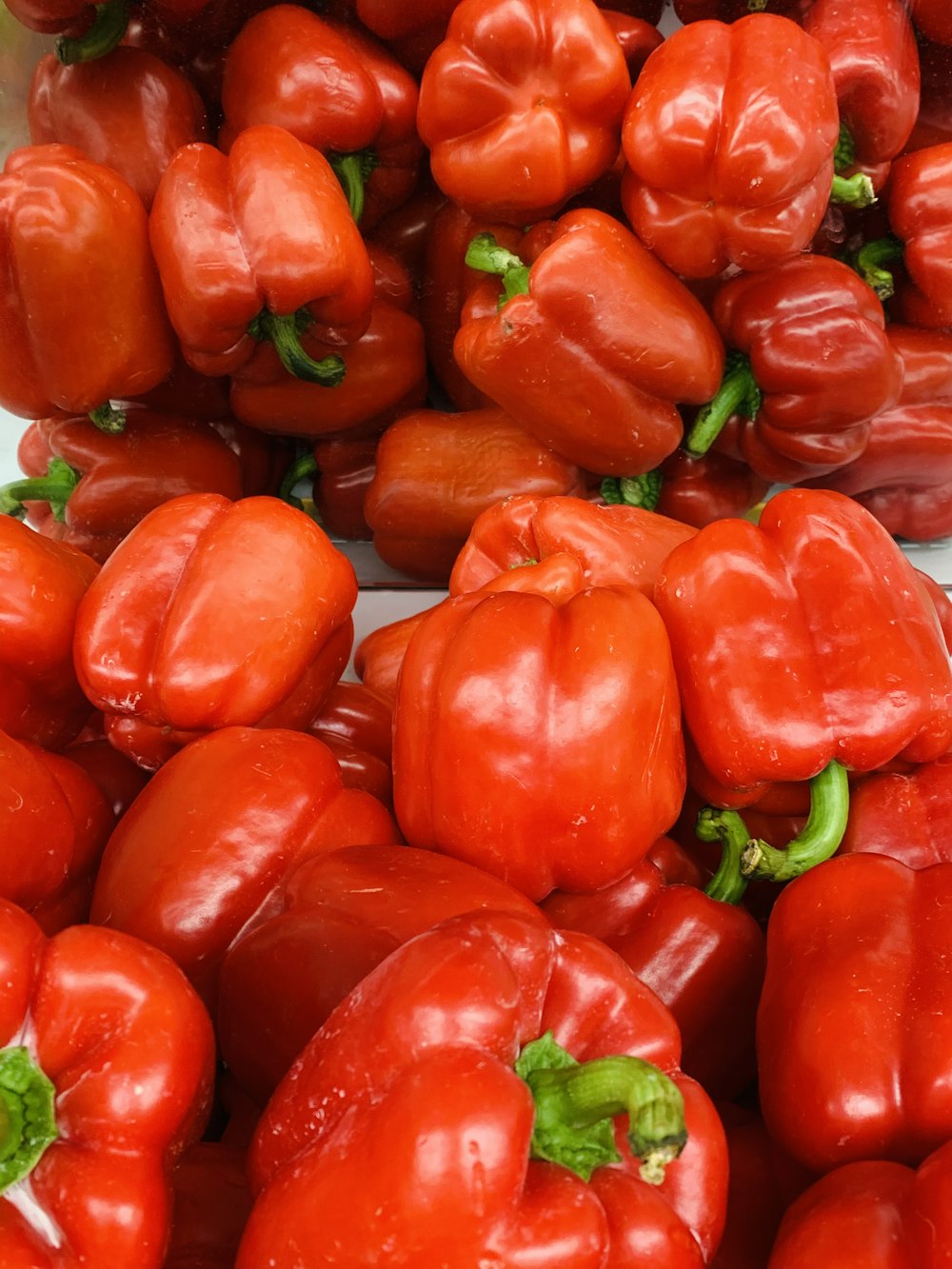 red bell peppers on brown wooden table