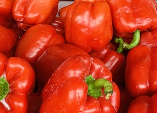 red bell peppers on brown wooden table