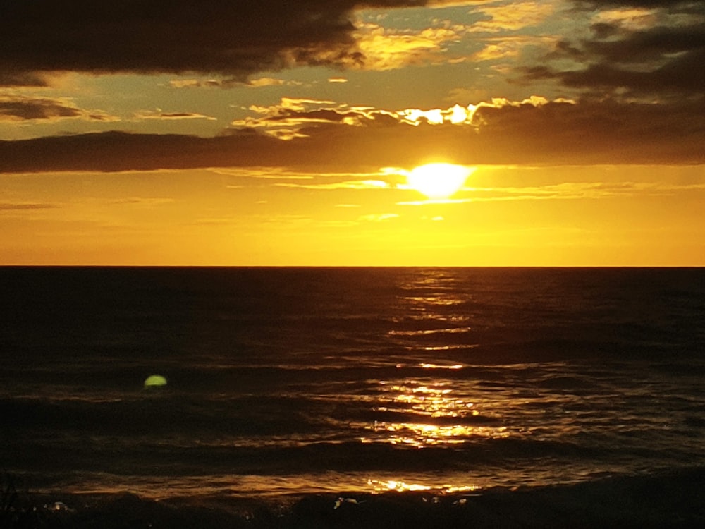 body of water during sunset