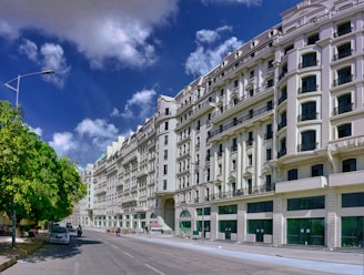 white concrete building near green trees during daytime