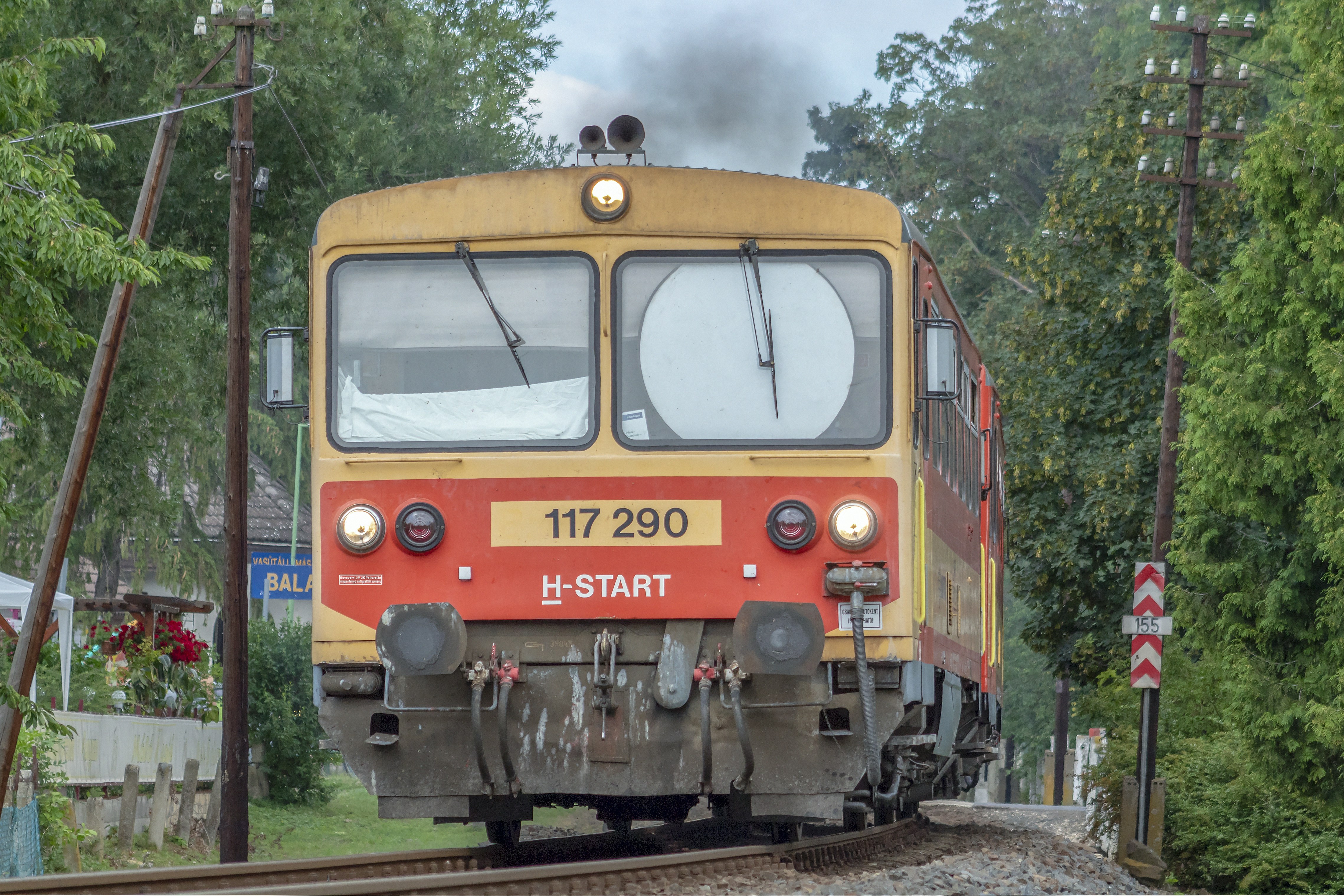 orange and blue train on rail tracks