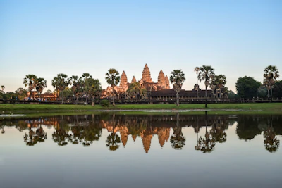 Wide shot of Angkor Wat with the moat and grounds (via Unsplash)