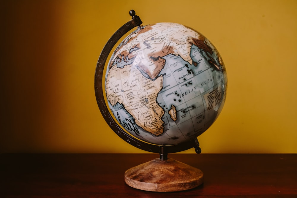 white and brown desk globe