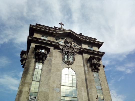 brown concrete building under blue sky during daytime in University of Santo Tomas Philippines