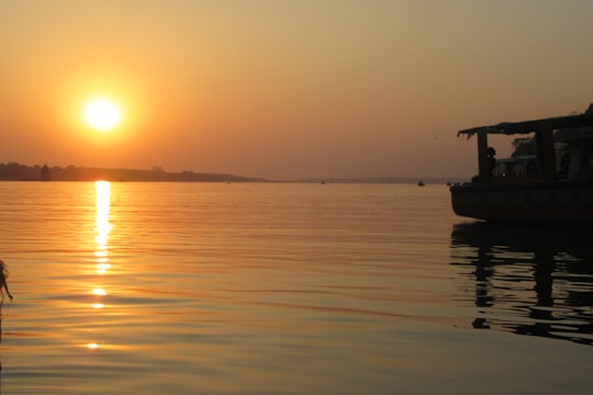 silhouette of boat on sea during sunset in Maheshwar India