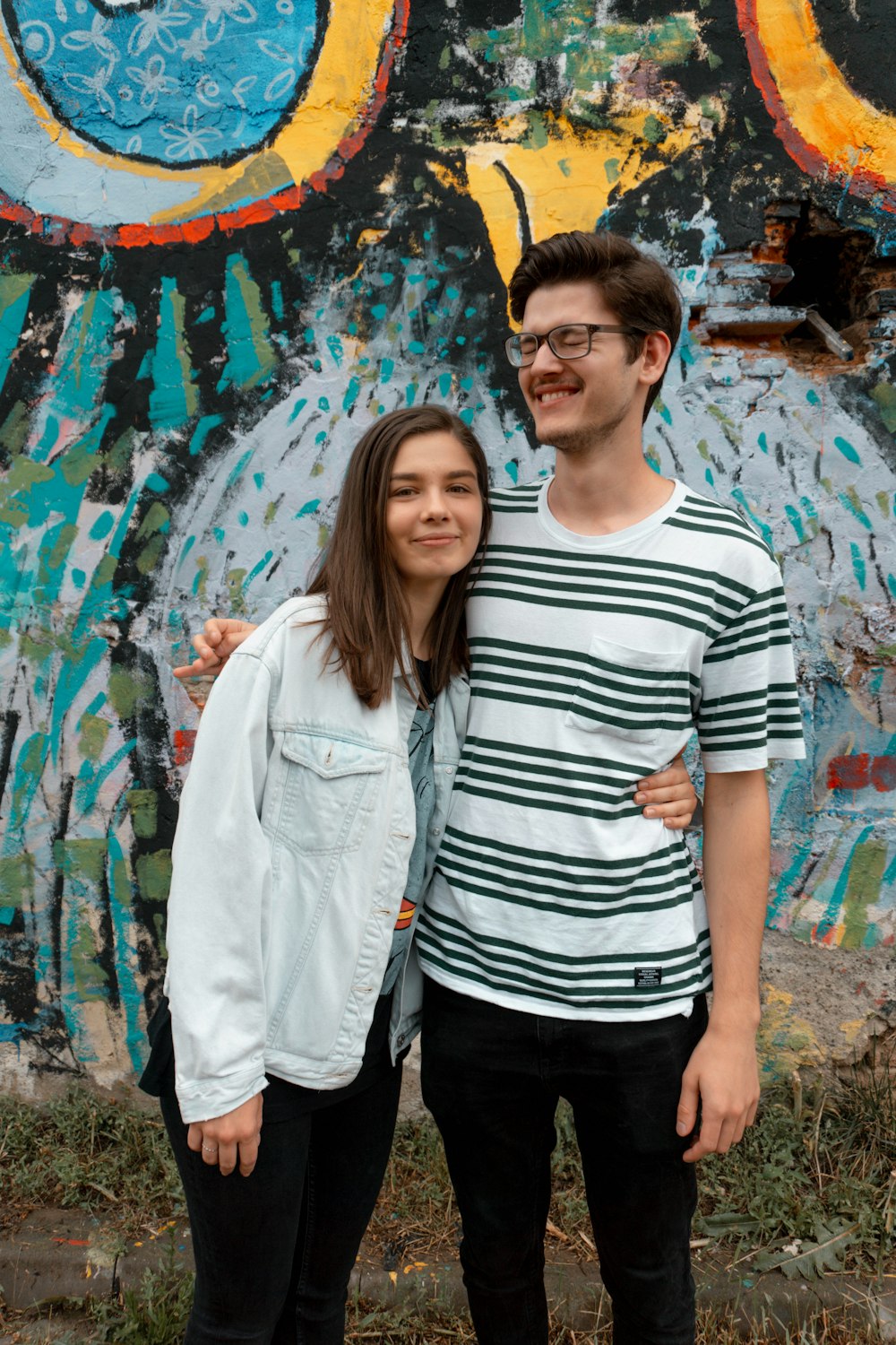 woman in black and white striped crew neck t-shirt standing beside woman in white jacket