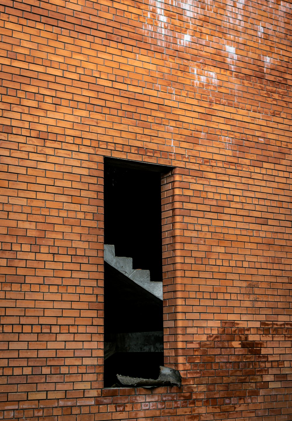 brown brick wall with black window