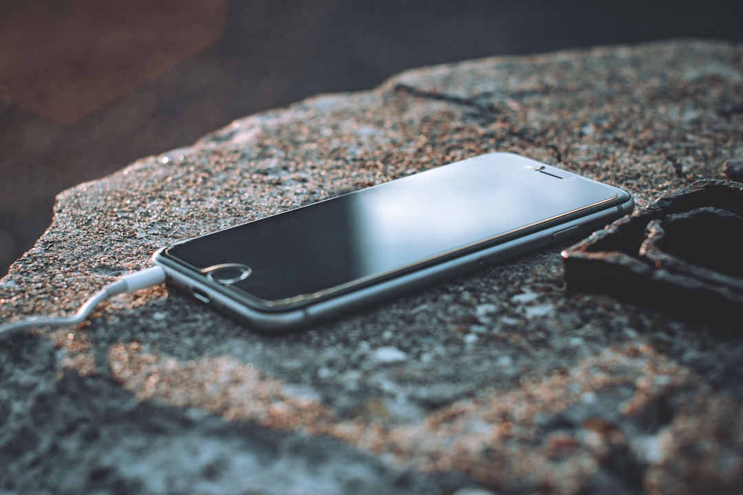 black iphone 5 on brown and black marble table