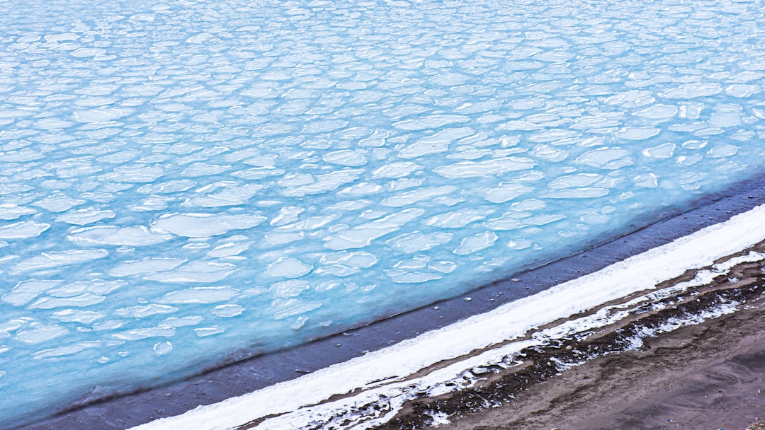 body of water near gray concrete wall