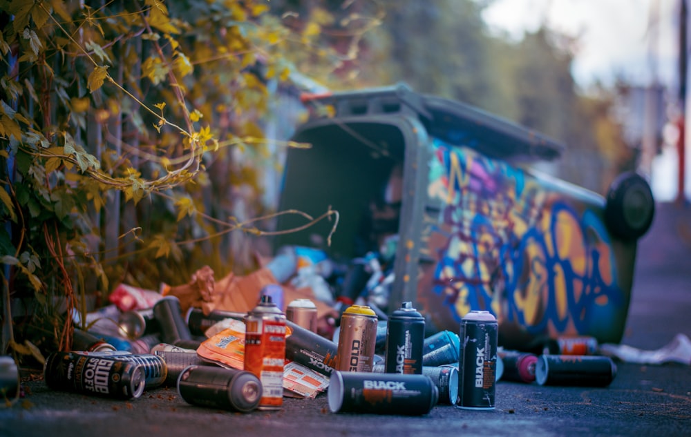 a group of cans and cans sitting on the side of a road