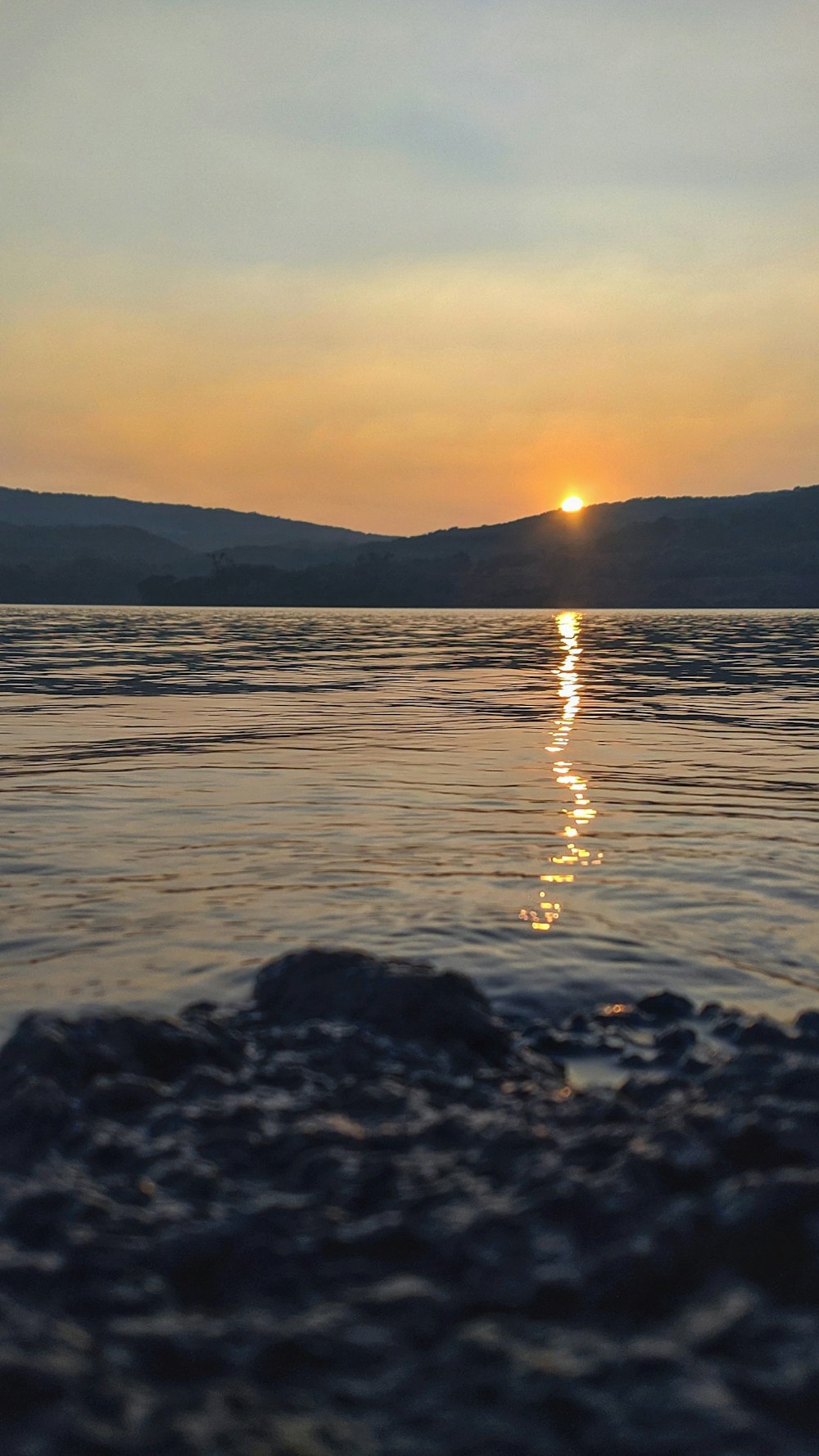 body of water during sunset