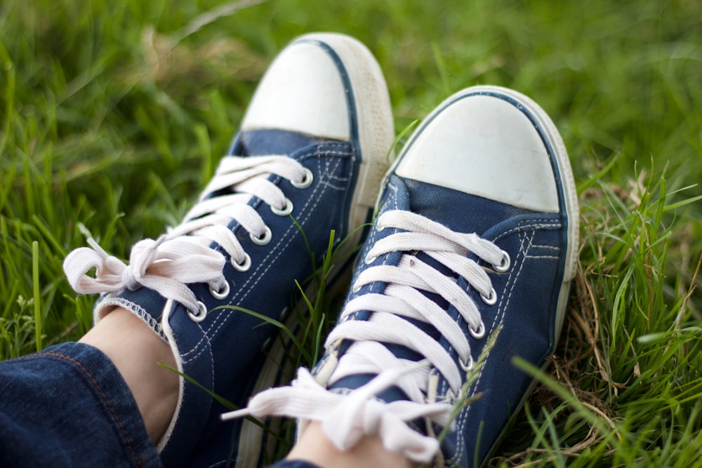 person wearing black and white sneakers